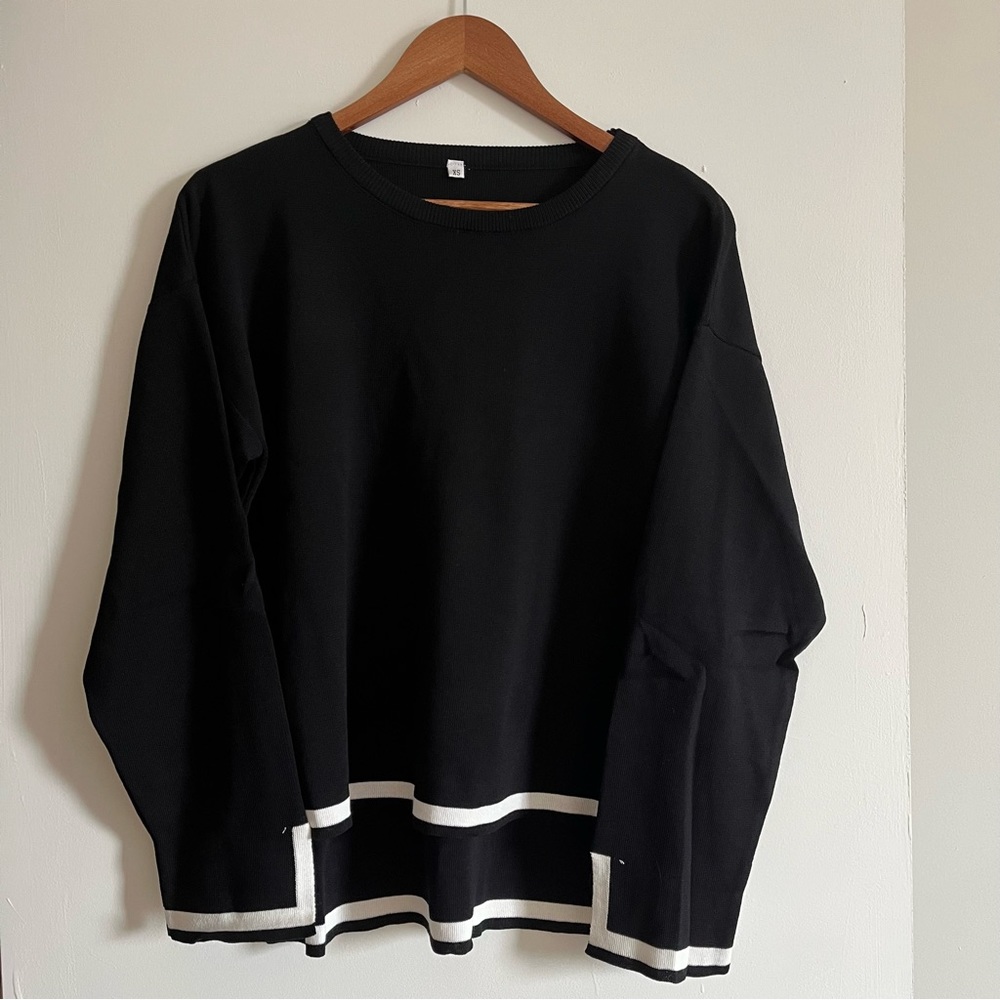 High-low long sleeve flowy black sweater with white trim